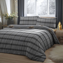 Load image into Gallery viewer, Plaid bedding set on a bed with pillows and a decorative tree in a bedroom.
