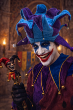 Load image into Gallery viewer, Person dressed as a jester with a colorful hat and costume, holding a small jester figure.
