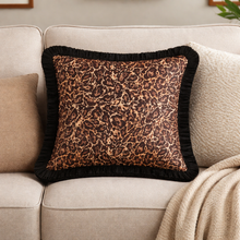 Load image into Gallery viewer, Leopard print pillow with black trim on a beige sofa
