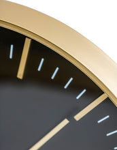 Load image into Gallery viewer, Close-up of a clock with gold rim and black face
