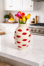 Load image into Gallery viewer, Decorative vase with red lip prints on a kitchen counter
