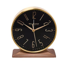 Load image into Gallery viewer, Round clock with gold frame and black face on a white background

