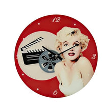 Load image into Gallery viewer, Wall clock with a design of a woman and movie clapperboard on a red background
