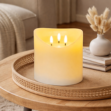 Load image into Gallery viewer, Three-wick candle on a wooden table with a vase of dried plants in the background
