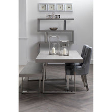 Load image into Gallery viewer, Modern dining room with a table, chairs, and decorative elements.

