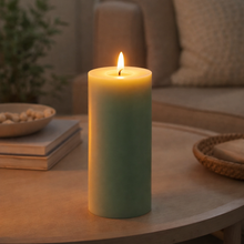 Load image into Gallery viewer, Lit candle on a table with a cozy indoor setting
