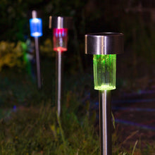 Load image into Gallery viewer, Solar garden lights on metal stakes outdoors at night, with one in sharp focus glowing green in the foreground and two more blurred in the background glowing blue and red.
