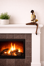 Load image into Gallery viewer, Fireplace with a mantel featuring a decorative statue and potted plant.
