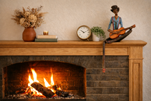 Load image into Gallery viewer, Fireplace with wooden mantel displaying decorative items including a clock, vase with flowers, and figurine.
