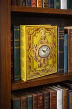 Load image into Gallery viewer, Decorative book with clock design on a wooden shelf with other books
