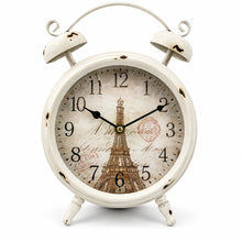 Load image into Gallery viewer, A vintage-style white alarm clock with a distressed finish, featuring a printed Eiffel Tower design on the clock face and black Arabic numerals, set against a plain white background.
